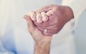 Doctors hand holding a patient's hand, close up